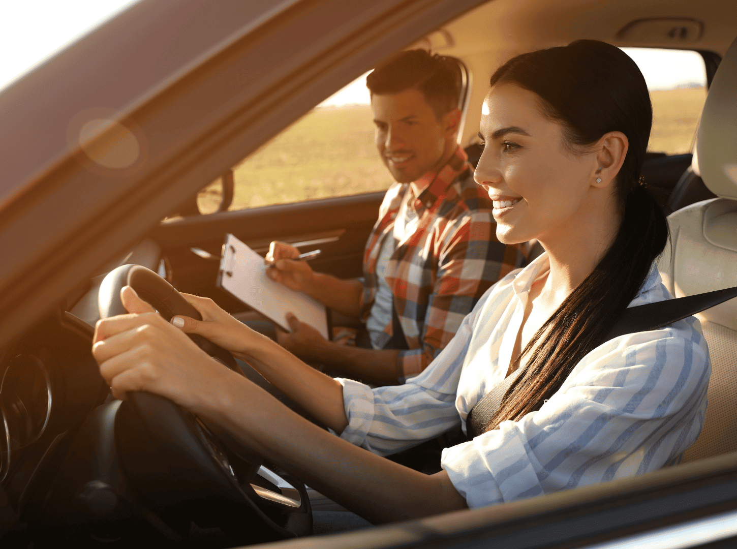 Happy woman reviewing her driving progress with an instructor during private driving lessons at Capital Auto Driving School
