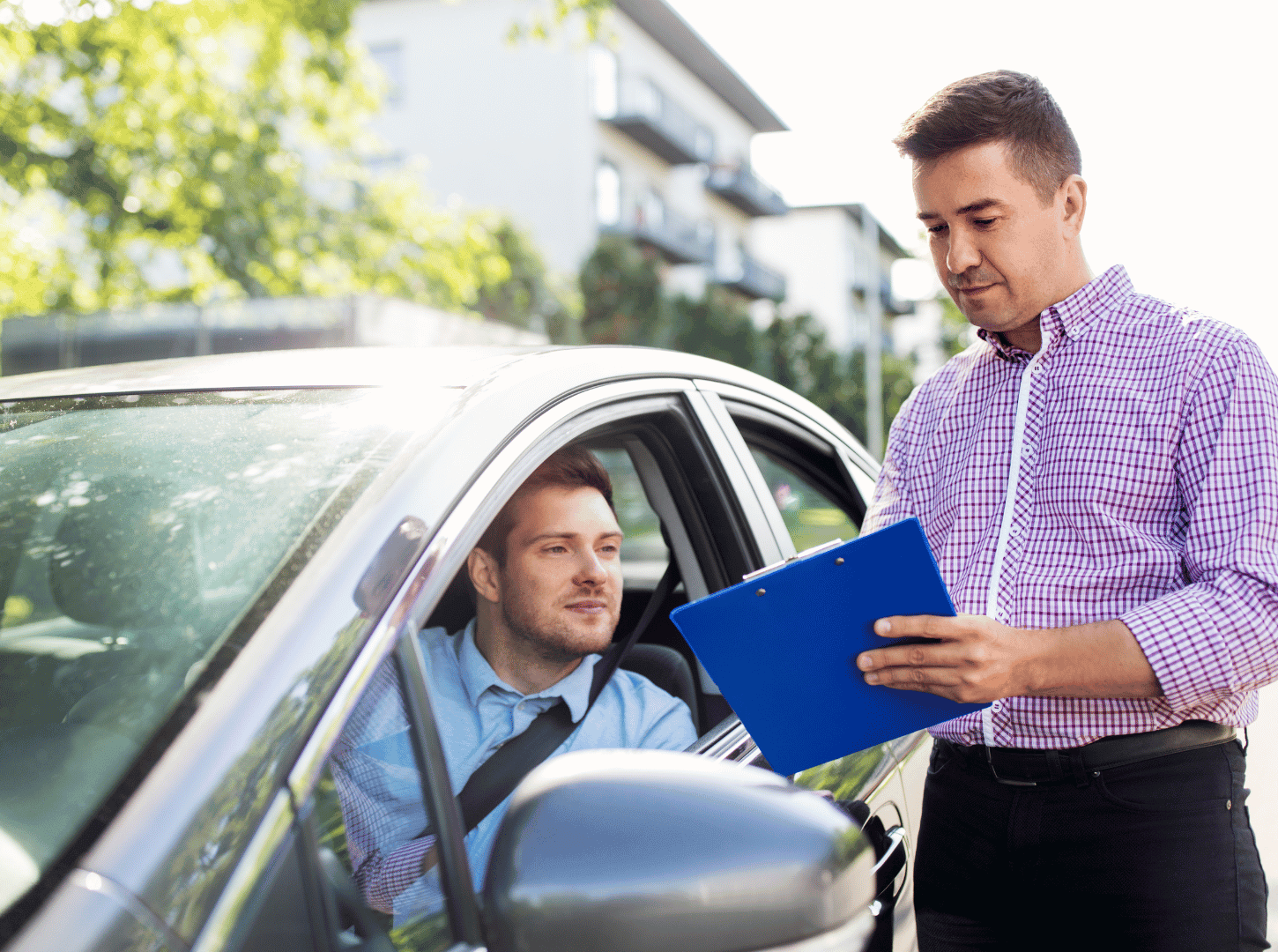 Student using a rental car for the road test, while the examiner reviews paperwork at Capital Auto Driving School